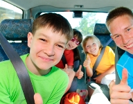 Photograph of a man and kids in a car