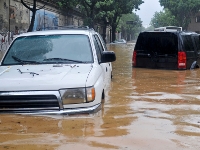 Photograph of a car half submerged in water