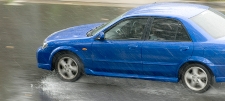 Photograph of a car hydroplaning on a deep sheet of water