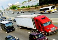 Photograph of car passing a truck on the freeway