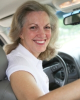 Photograph of a man holding a steering wheel