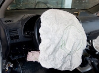 Photograph of a man holding a steering wheel